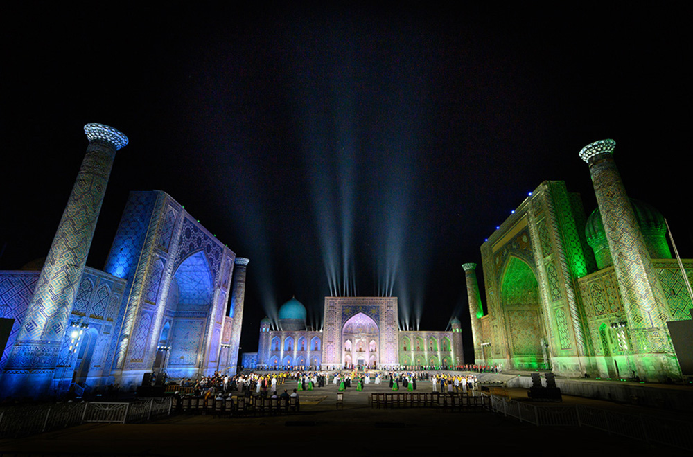 The Registan in Samarkand Uzbekistan lit up in blue green and white for a music festival 