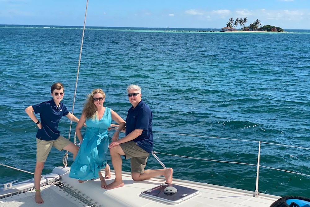 family posing on a private yacht on the ocean in Belize