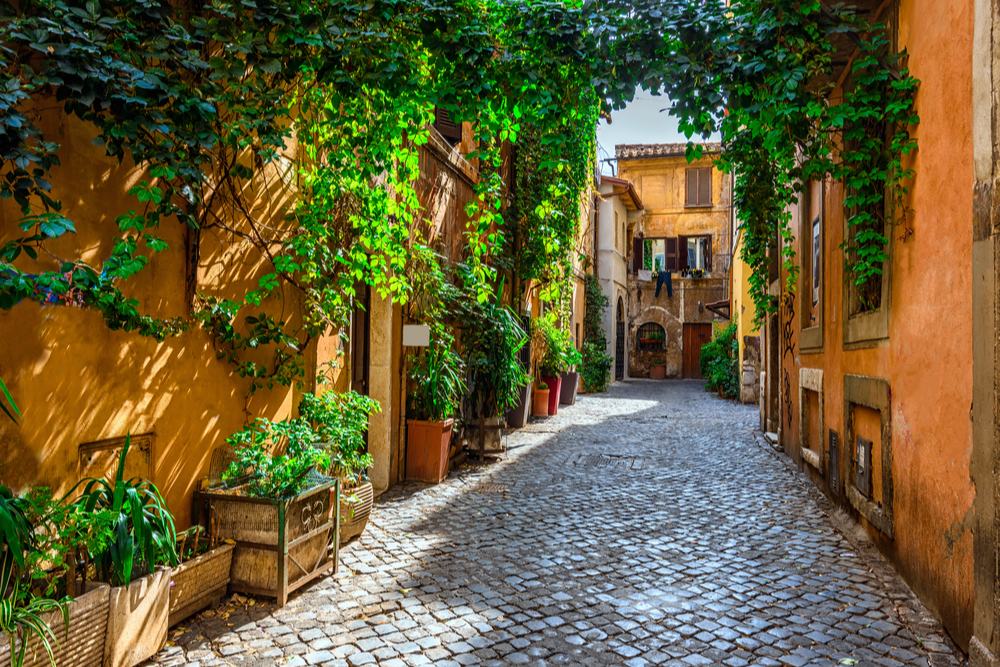 charming cobblestone street with ivy in Trastevere, Rome, Italy.