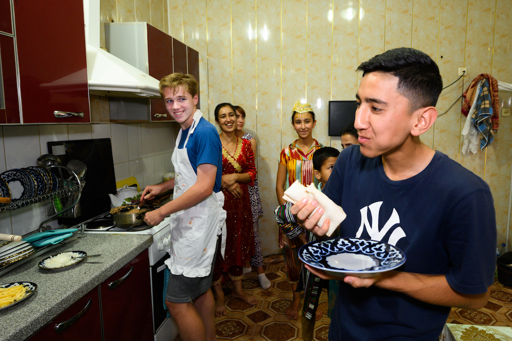 Uzbekistan - tourist boy cooking for local family in their home