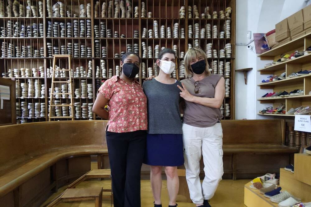 3 women posing at La Manual Alpargatera, oldest espadrilles shop in Barcelona