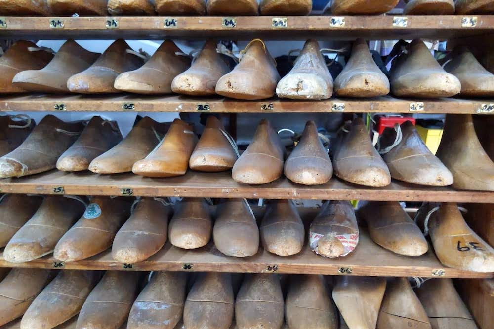 shoe molds on shelf at La Manual Alpargatera, oldest espadrilles shop in Barcelona