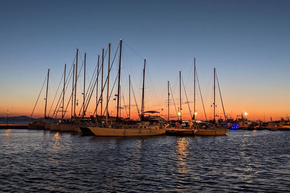 sunset over sailboats Naxos Town Greece