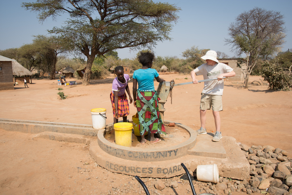 kids at a water pump in Chiawa Zambia