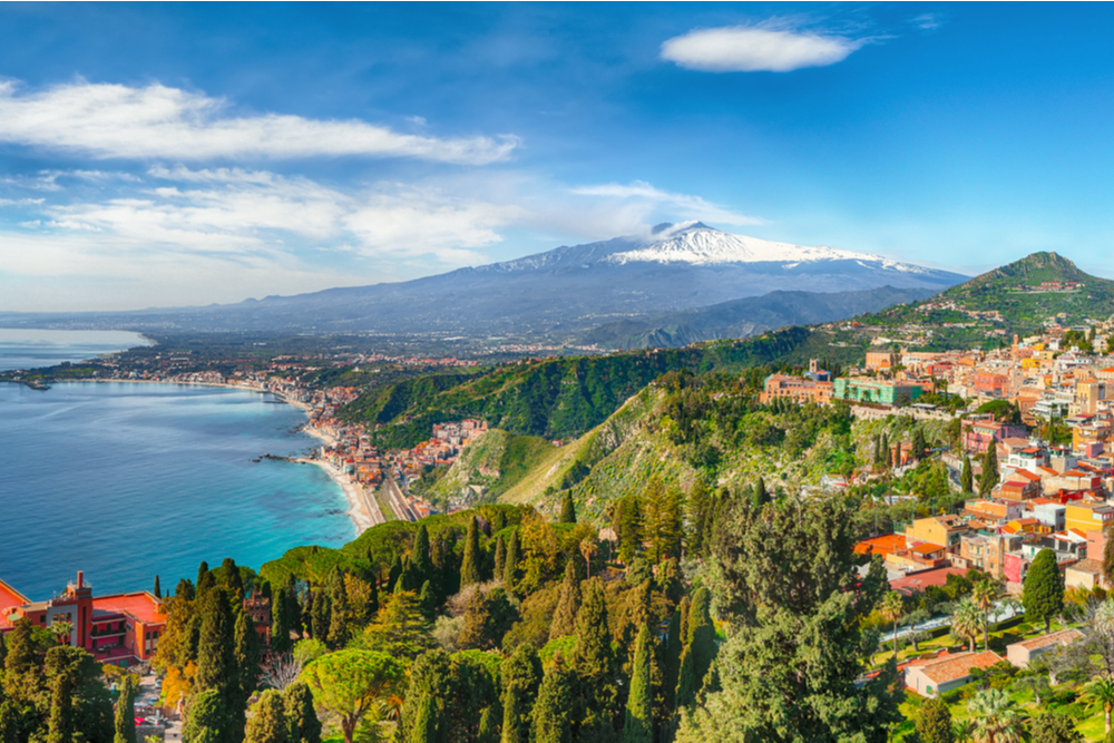 Aquamarine blue waters of sea near Taormina resorts and Etna volcano mount. Giardini-Naxos bay, Ionian sea coast, Taormina, Sicily, Italy.