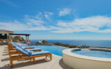 chaise longus by an infinity pool overlooking the ocean in Cabo Mexico