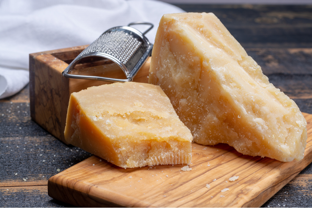 Traditional italian food - 36 months aged in caves Italian parmesan hard cheese from Parmigiano-Reggiano, Italy.