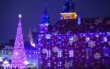 Christmas tree and projected snowflake lights on a building at the Warsaw Christmas market in Warsaw Poland