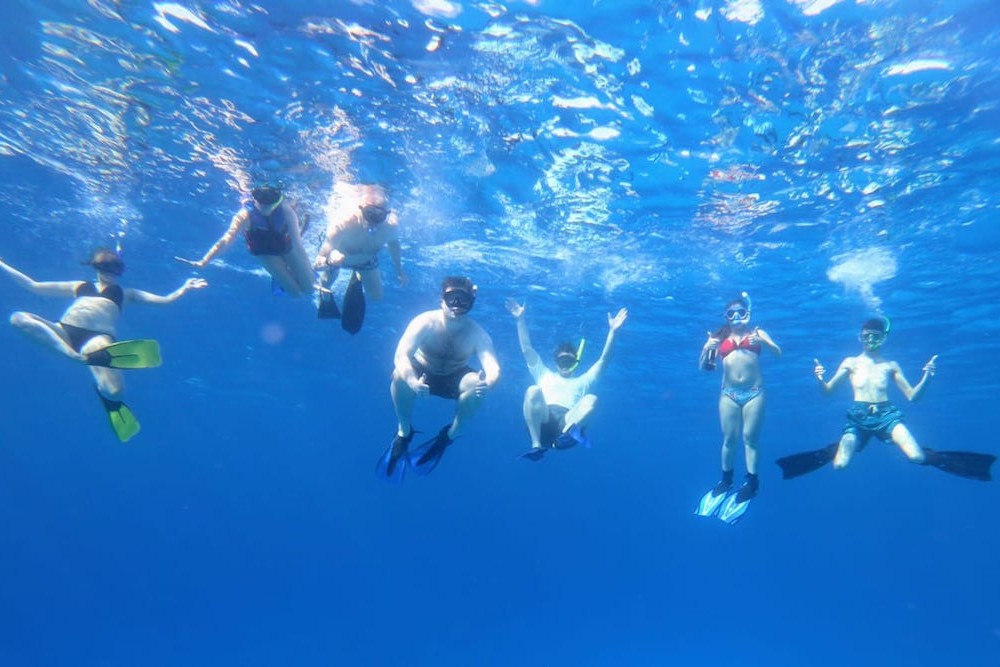 underwater photo of family snorkeling in Mexico