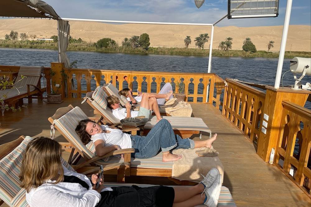 family lounging on a boat on the Nile