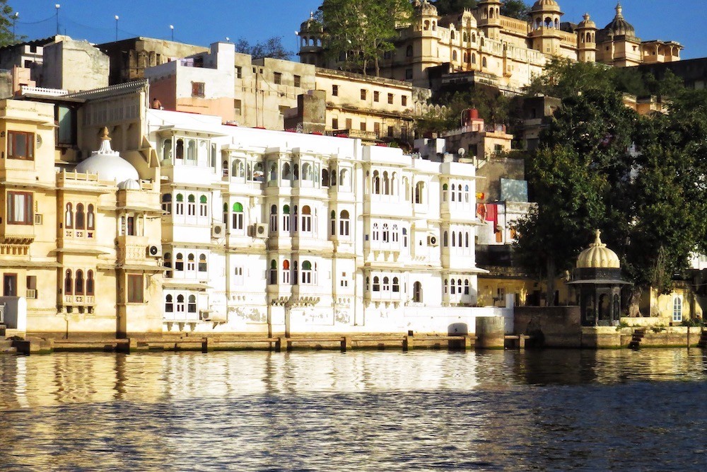 white building with colorful windows on lake of Udaipur India