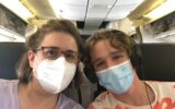 woman and son wearing masks on a plane