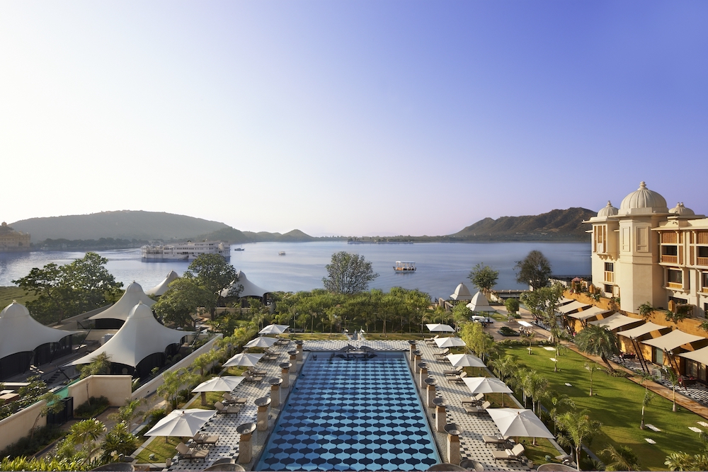 view of the pool of the Leela Udaipur Hotel in India overlooking the water