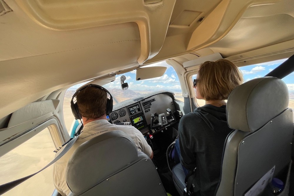 inside a charter flight with pilot and tourist woman South African safari