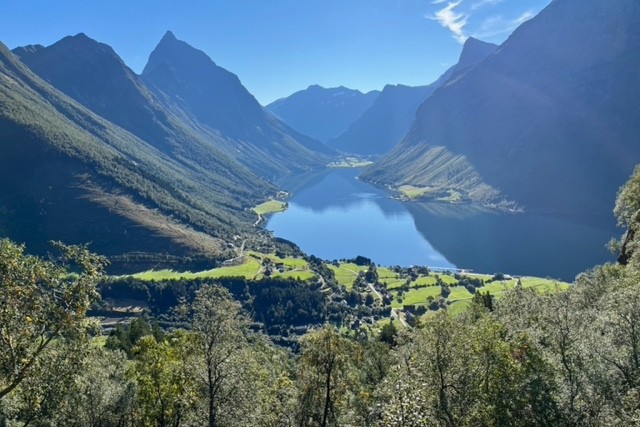 lake in Norway with green fjords and scenery surrounding it