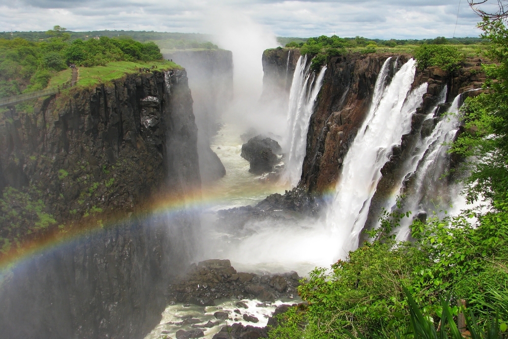 Rainbow over Victoria Falls on Zambezi River, border of Zambia and Zimbabwe.