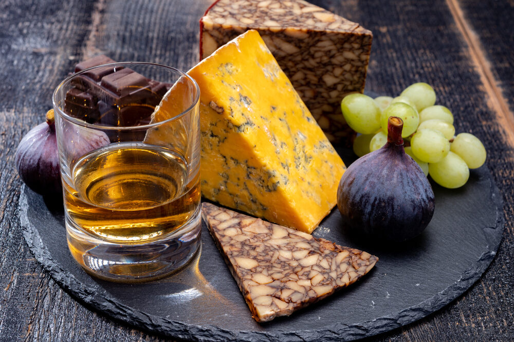 Appetizer plate of Irish blended whiskey and cheeses.