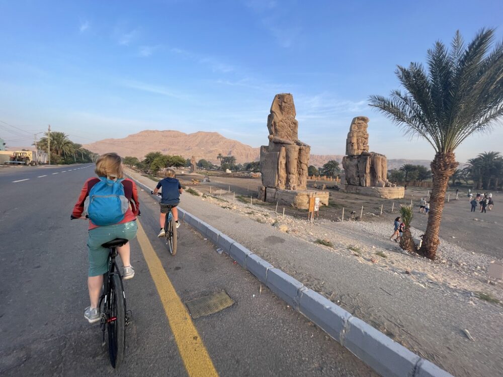 Brook and her son biking on an empty road to the Valley of the Kings in Luxor.