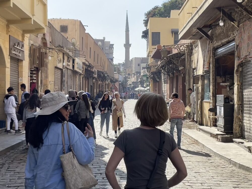 Strolling El Moez Street in Old Cairo along locals and other visitors.