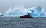 Checking out icebergs in Antarctica with expedition cruise ship specialists via inflatable Zodiacs.