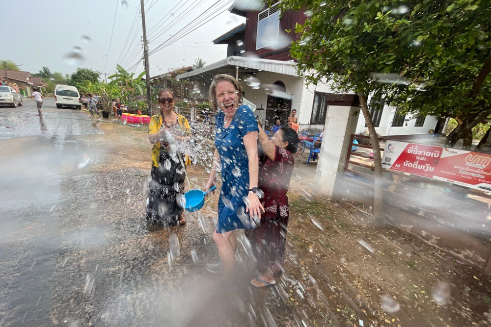 Brook getting water-splashed by a local during Songkran Water Festival.