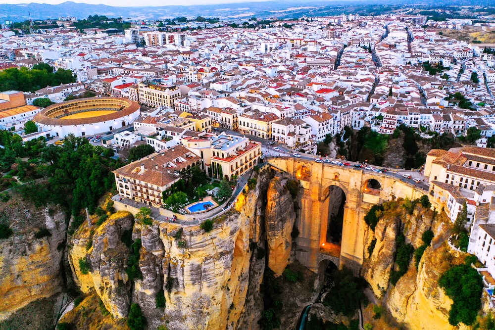 Aerial evening view of New Bridge over Guadalevin River in Ronda, Andalusia, Spain.