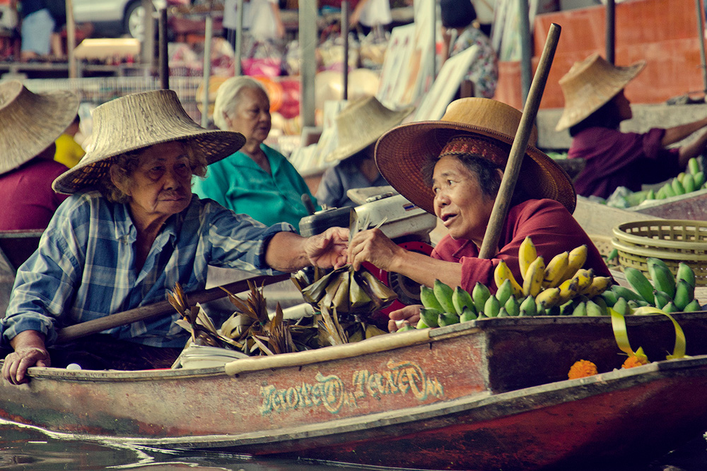 Sellers on a boat at the traditional floating market in the Bangkok canals.