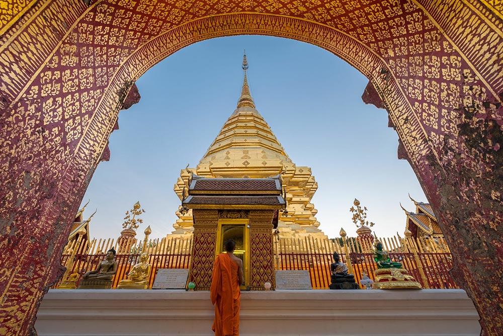 A woman in front of Wat Phra That Doi Suthep in Chiang Mai, Thailand.