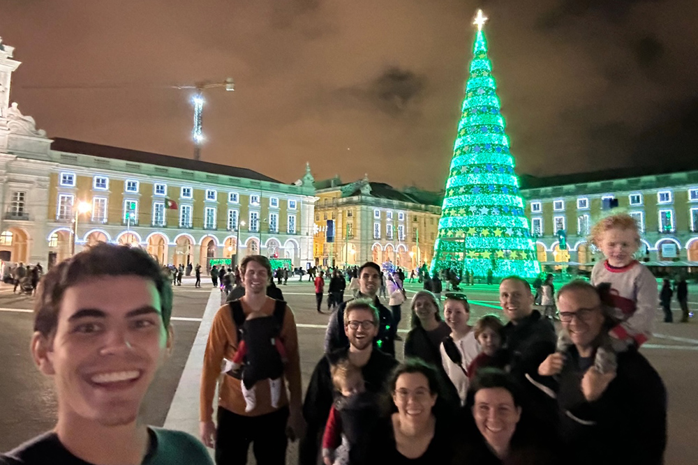 A beautiful selfie of Michelle Bodine and family in Lisbon with a Christmas tree in the background.