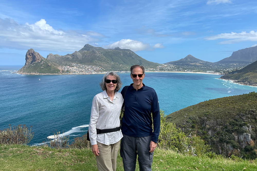Mike Modak and his family in Cape Town with a beautiful landscape in the background.