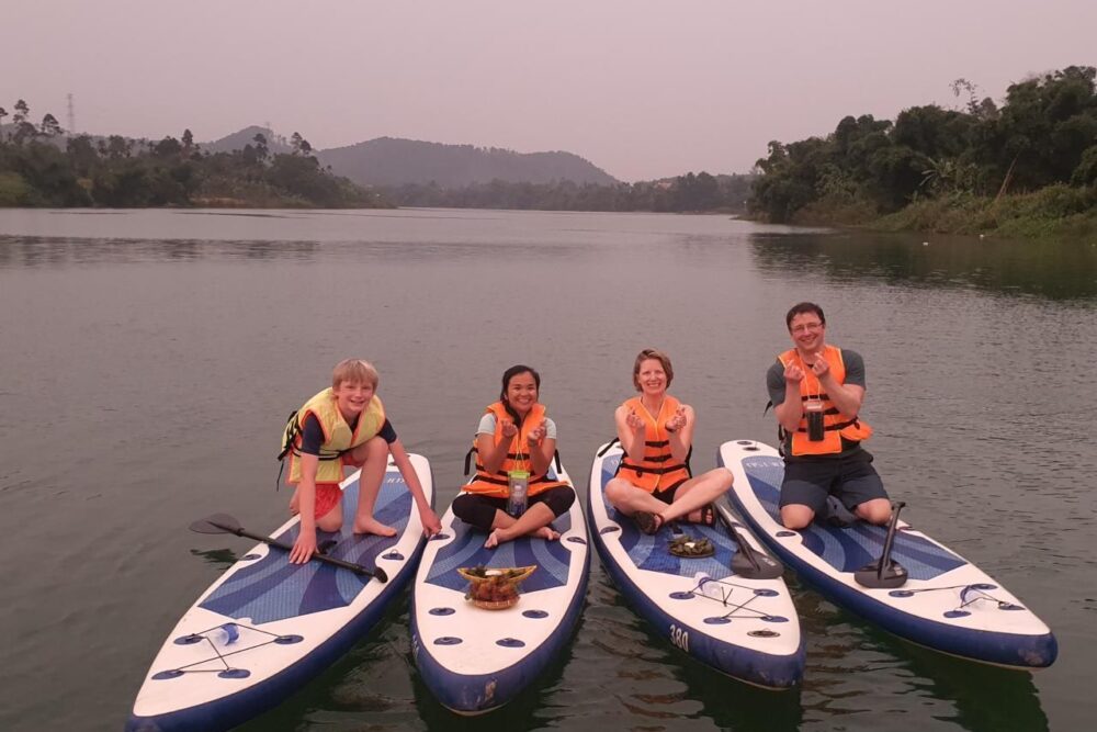 Brook, her family, and a guide Paddleboarding on Perfume River.