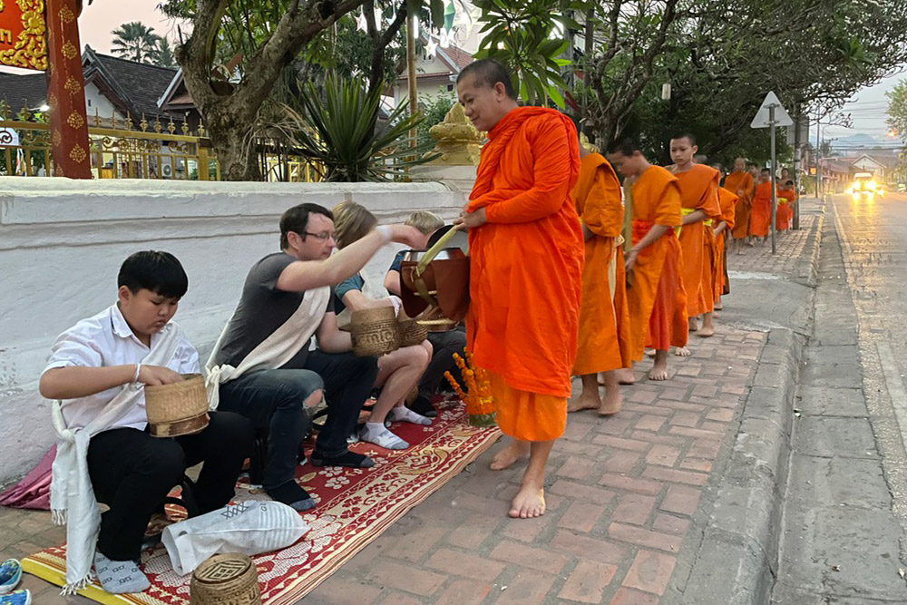 Brook and family doing a morning ritual giving offerings.