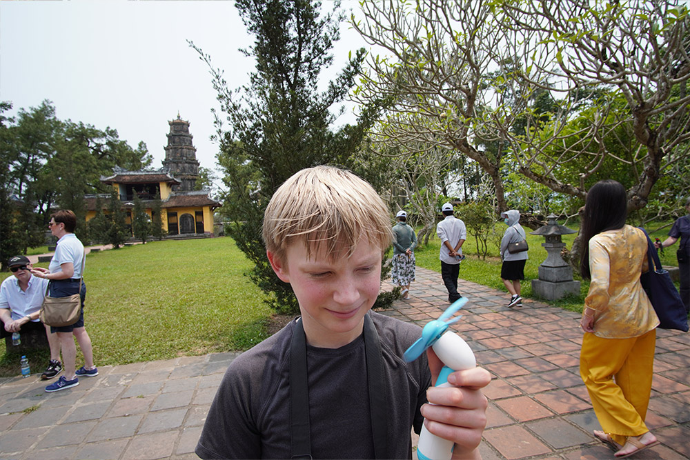 Zeke holding a handheld fan.