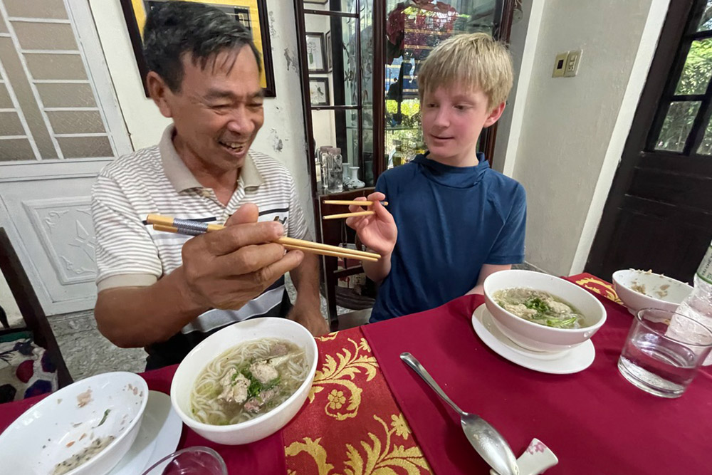 Zeke having a chopstick lesson.