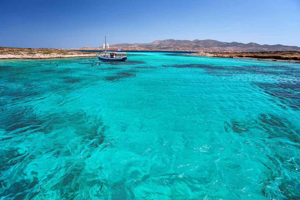 Blue Lagoon in Tigani islet between Paros and Antiparos islands, Cyclades, Greece, with clear transparent turquoise waters.