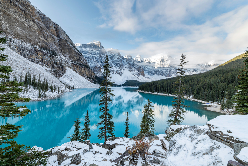 Moraine Lake surrounded by snow covered mountains during Christmas time in Banff National Park, Canada. 