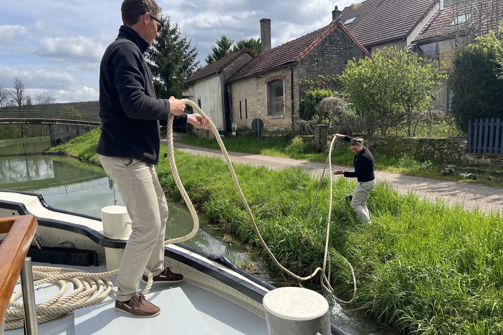 Two crew members tie up the barge in a village on the Canal de Bourgogne.