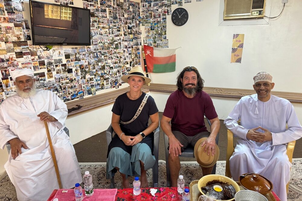 Amy Avers and her husband having coffee and dates with Omani locals.