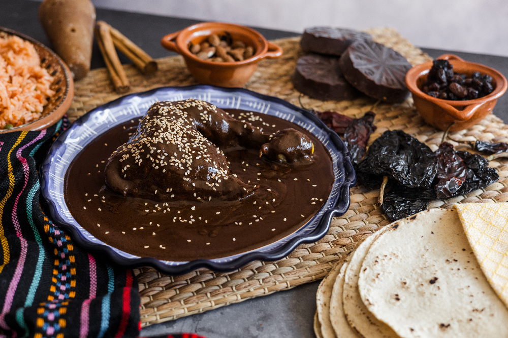 Mole Poblano on a plate with sesame seeds on top.