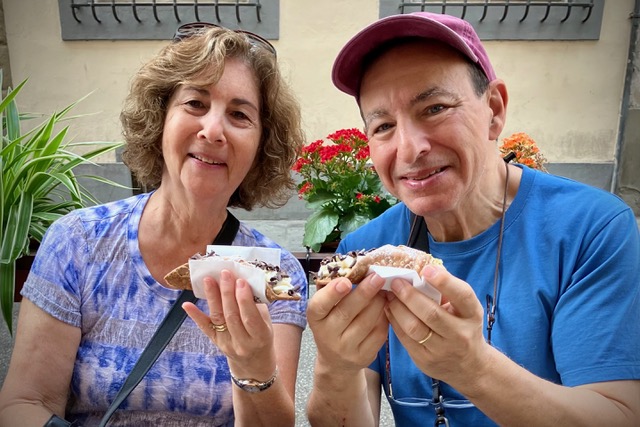 Travelers enjoying cannolis in Florence.
