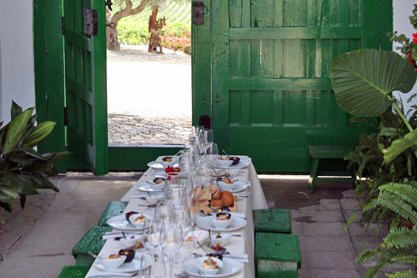 Country lunch setup with green chairs and old green entrance door.