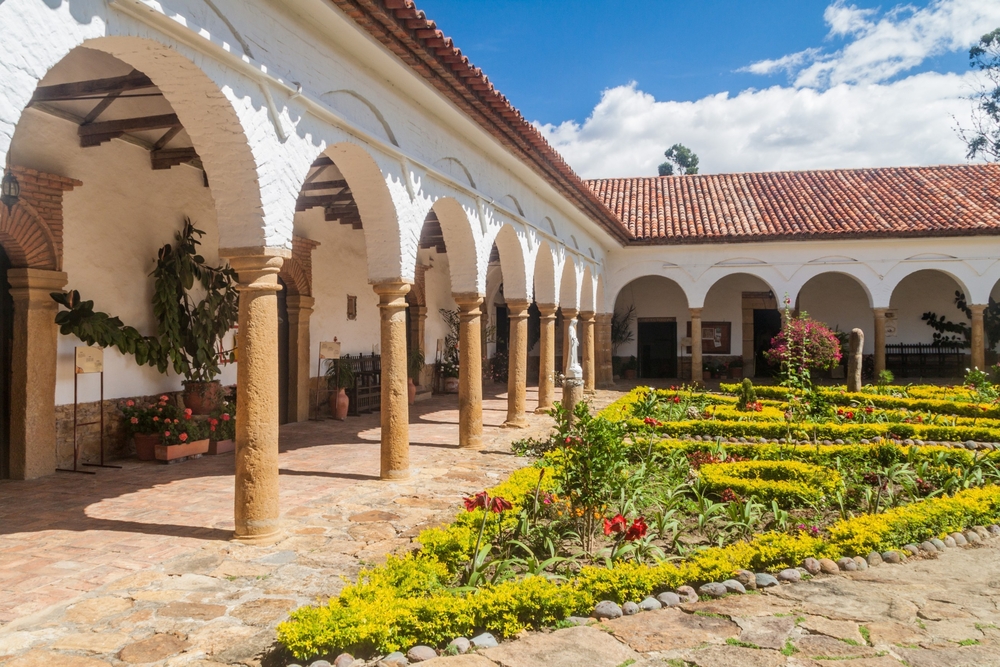 The courtyard of a convent santo ecce homo with beautiful greenery in the center.