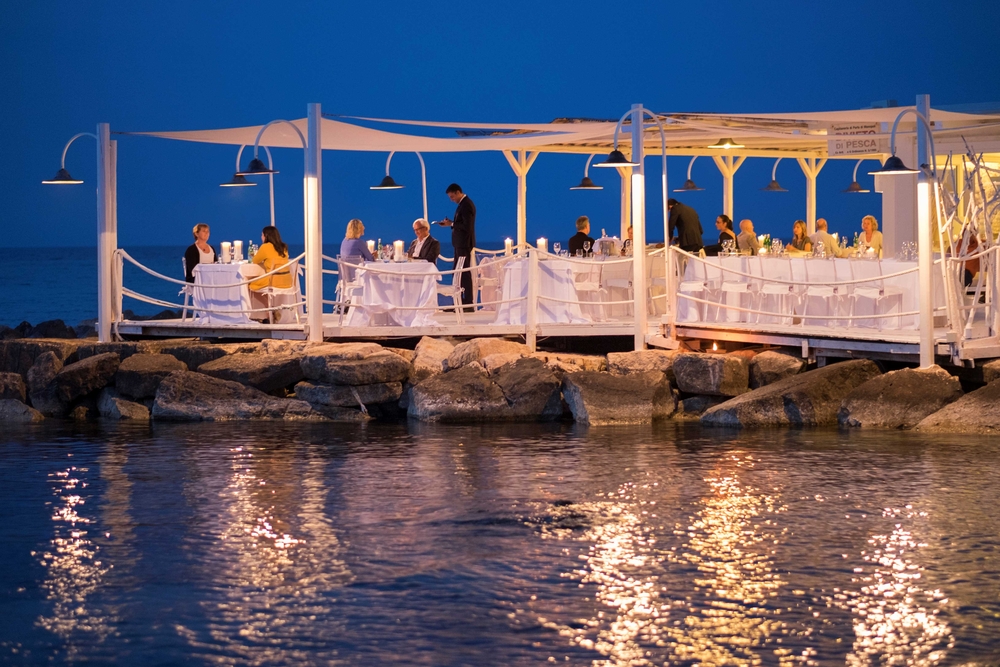 People dining at a restaurant on the coast in Puglia.