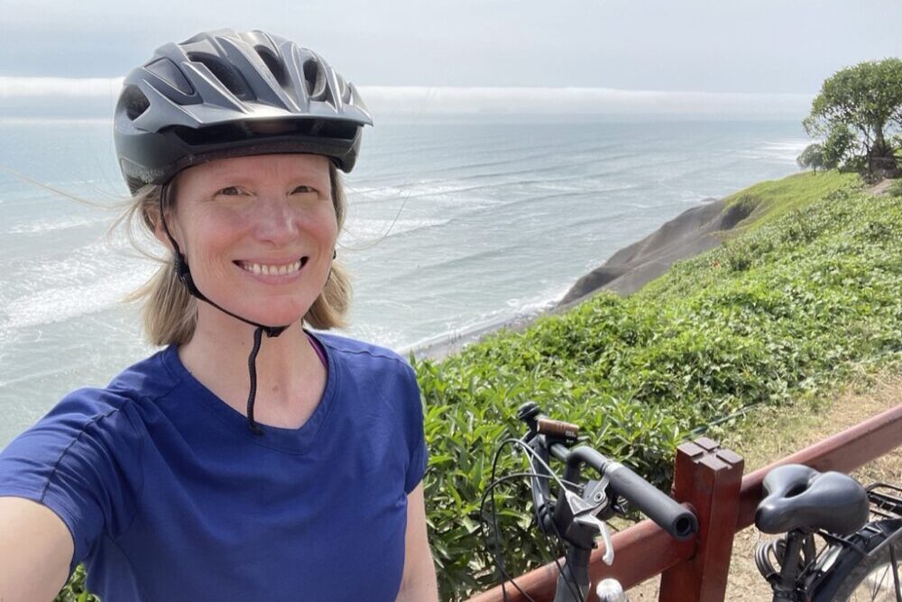 Brook biking along a seaside path in Lima, Peru.