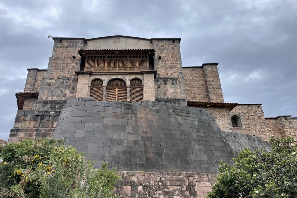 The Coricancha temple in Cusco from the outside on a cloudy day.