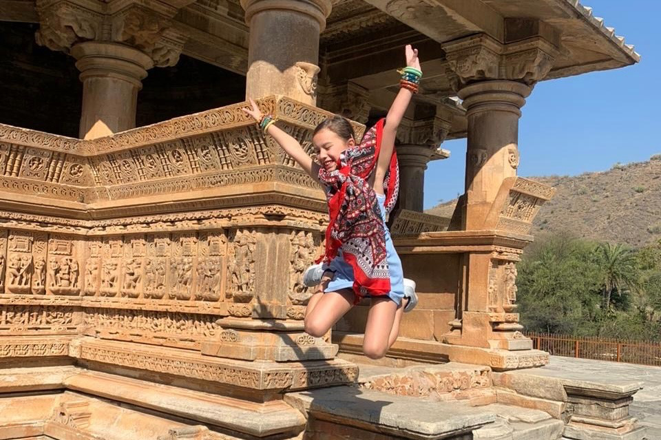 Little girl jumping out at Eklingji Temple, near Udaipur in India.