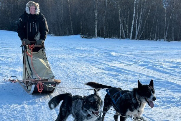 Traveler Jim Braun running his team of dogs in Alta, Norway.