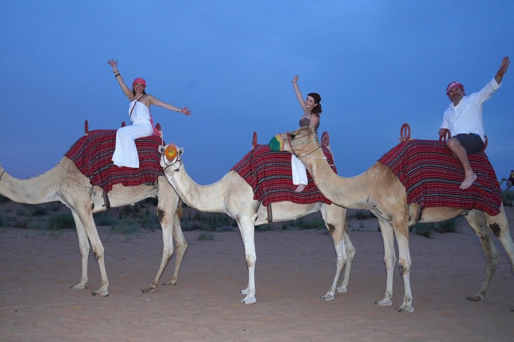 Lauren Schor and her family riding camels in Dubai.