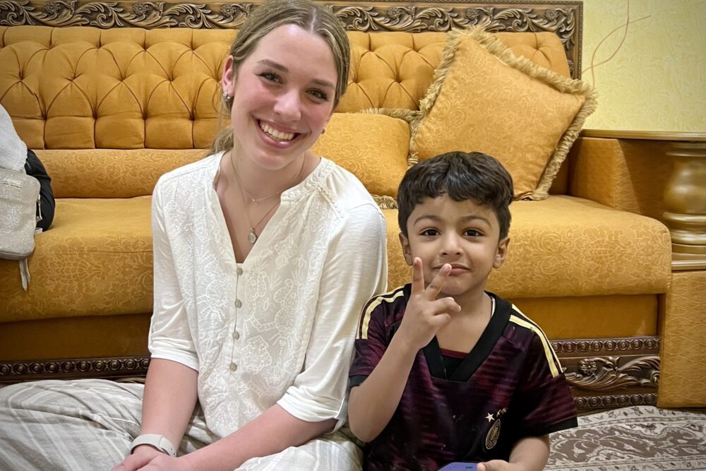 Tracy Reller's daughter with a local little boy during the meal in Oman.