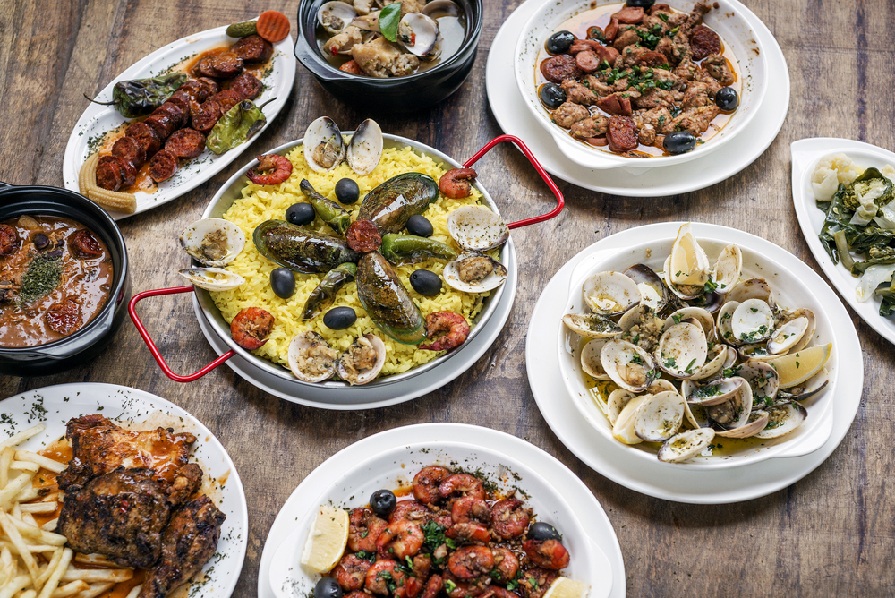 Mixed Portuguese tapas on a wooden table.